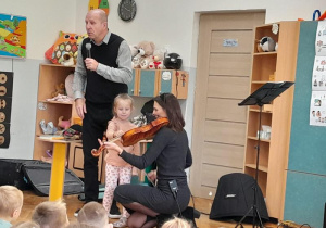 Dziewczynka próbuje grać na instrumencie