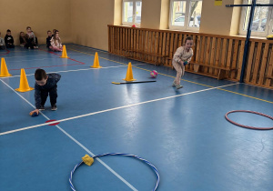 Dzieci biorą udział w konkurencji sportowej z rzucania do celu