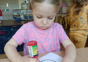 Dziewczynka maluje jabłko
