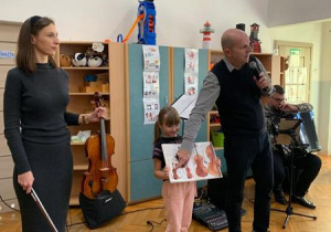 Dziewczynka pokazuje dzieciom instrumenty