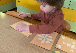 Dzieci układają wzory z figur geometrycznych