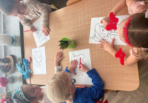 Dzieci wykonują prace plastyczną "Pinokio"