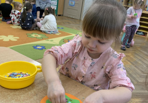 Dziewczynka wykonuje pracę plastyczną - pączka