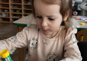 Dziewczynka wykonuje pracę plastyczną