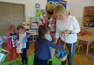 Pani wicedyrektor i nauczycielka wręczają nagrody przedszkolakom