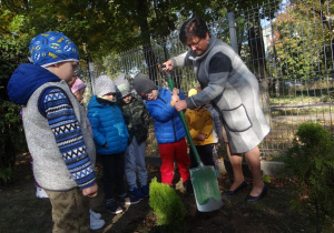 Chłopiec zasypuje dołek